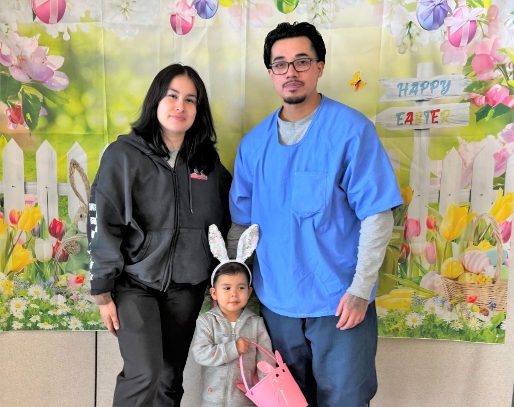 Mother and child visiting an incarcerated loved one at CCI for Easter.