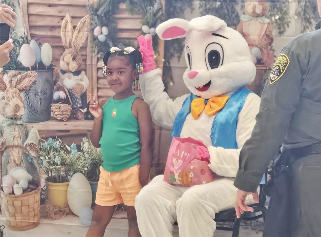 Easter bunny poses for a photo with a child at Central California Women's Facility in Chowchilla, Calif.