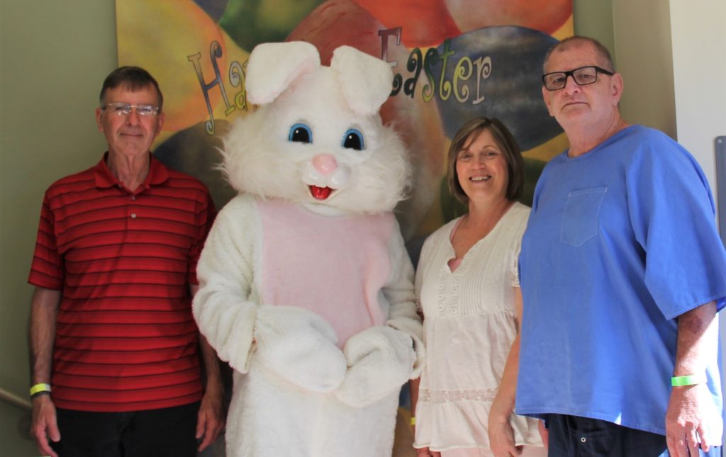 A photo with Peter Rabbit, two visitors and an incarcerated person at CHCF.