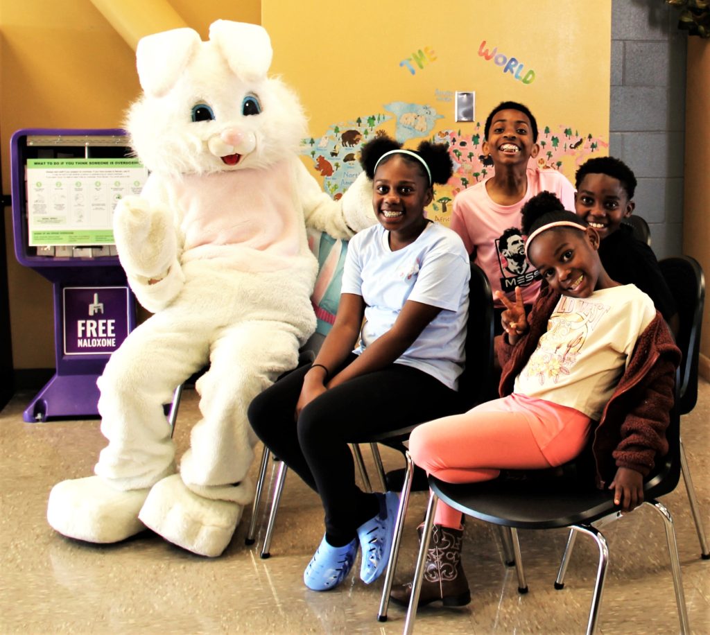A family poses for a photo with Peter Rabbit at CHCF.