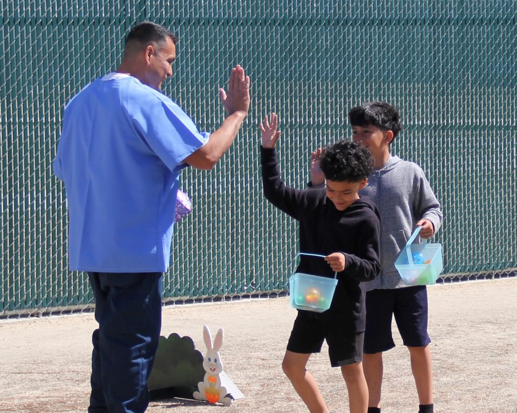 High fives from two kids after hunting Easter eggs at CHCF in Stockton, California.