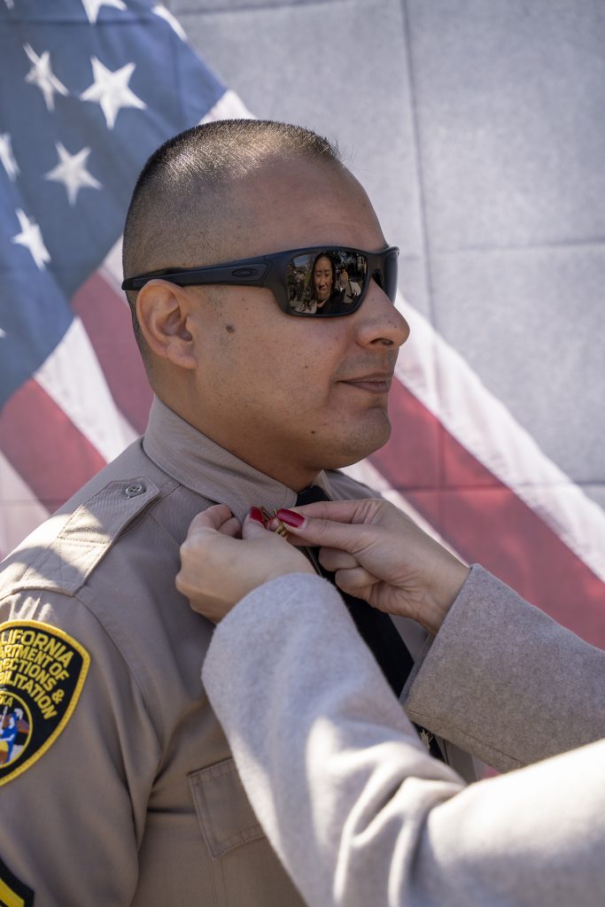 A man receives his sergeant's rank. 