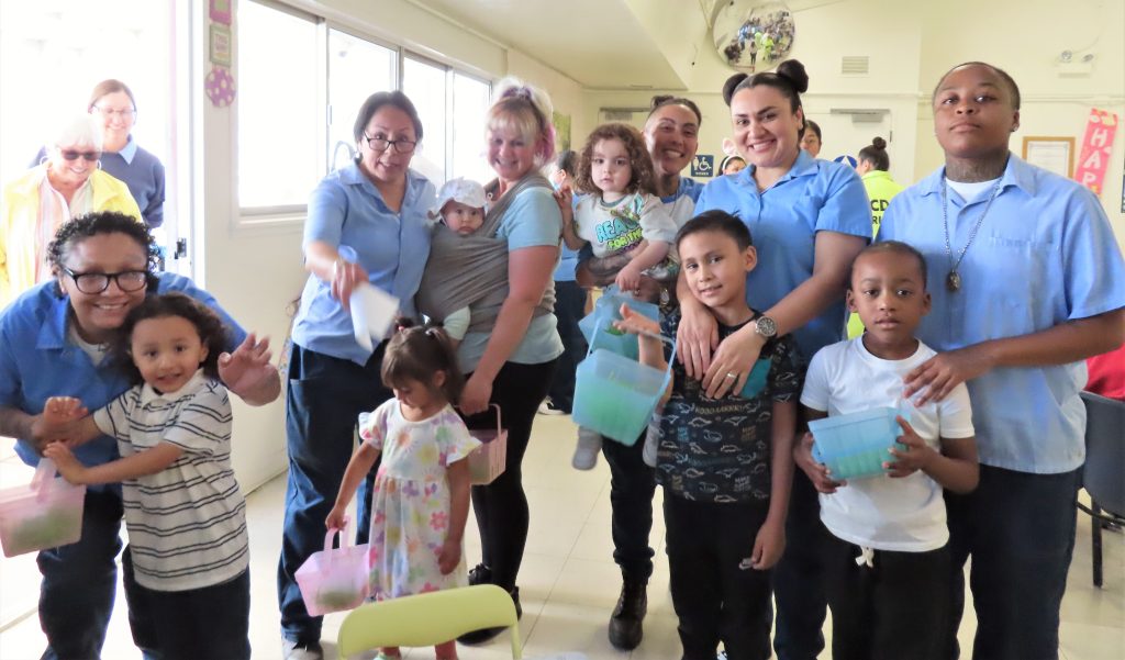 Group photo of incarcerated Women and their visiting family members for Easter at California Institution for Women in Chino, Calif., April 20, 2025.