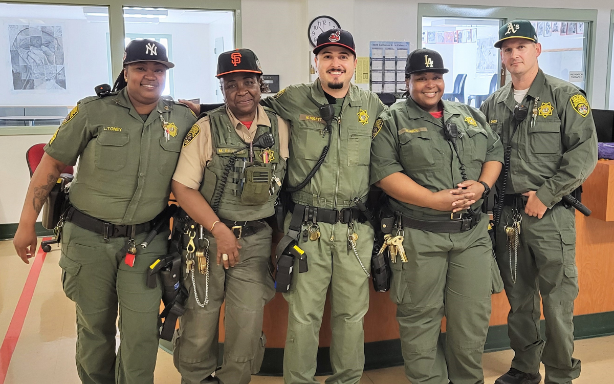 CMF staff with team baseball hats.