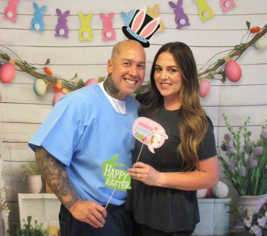 A couple posing for an Easter themed photo at CSP-Corcoran, a CDCR facility, during a visiting event.