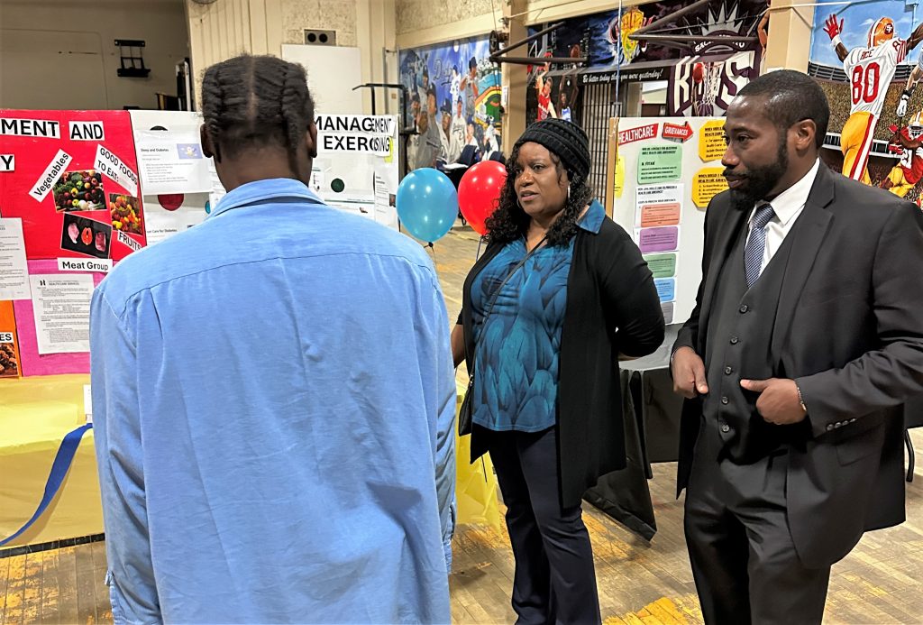 An incarcerated person gets information at a CTF health fair as part of patient safety week.