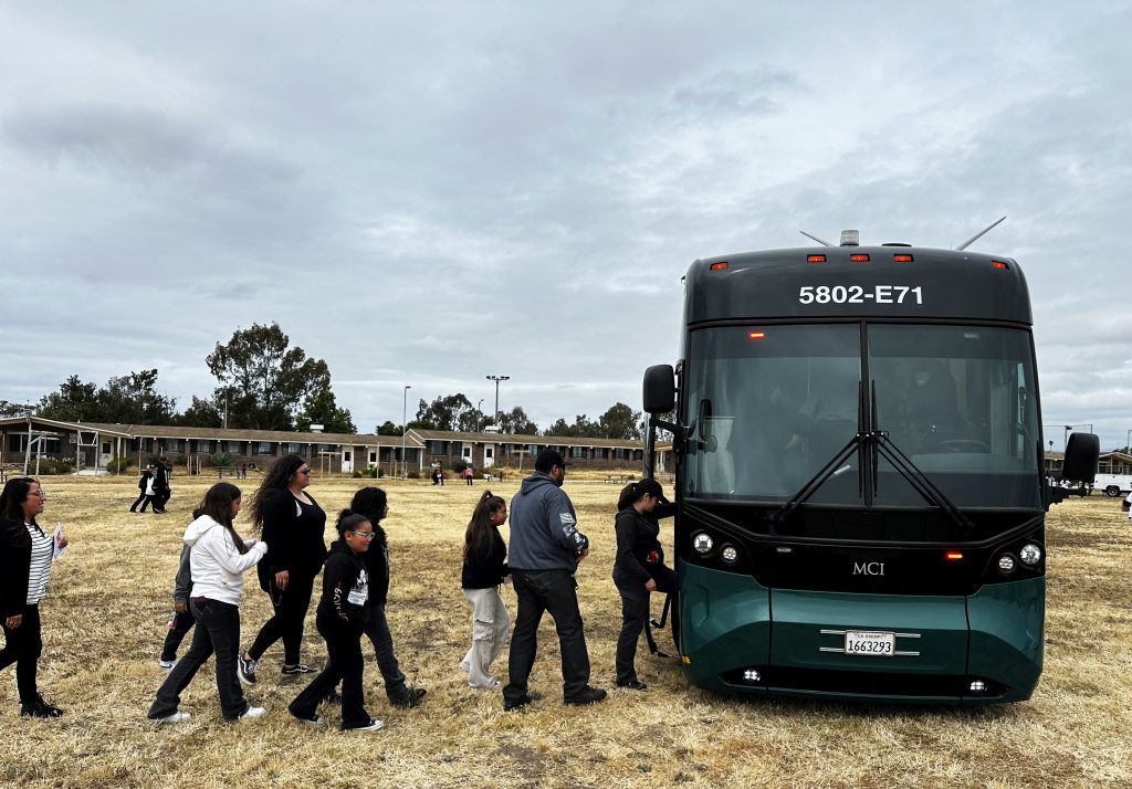 Children and parents board a CDCR state transportation bus at the Correctional Training Facility Take Your Kids to Work Day in Soledad, Calif.