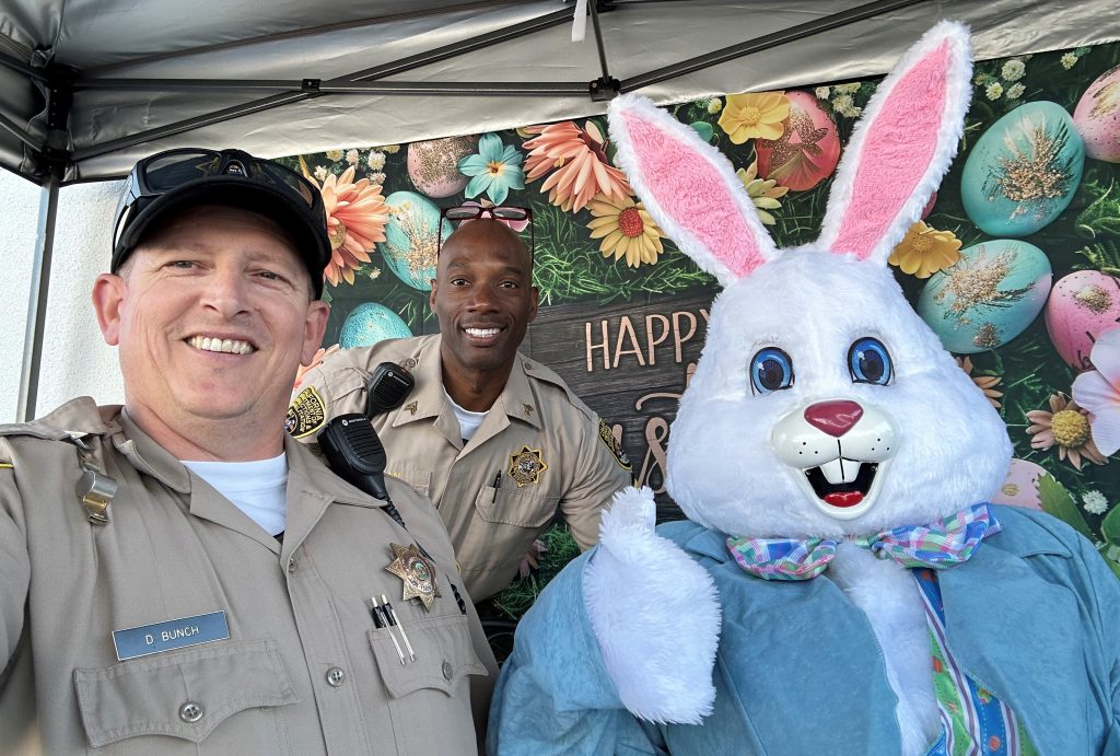 Two CDCR staff members with the Easter bunny at Folsom.