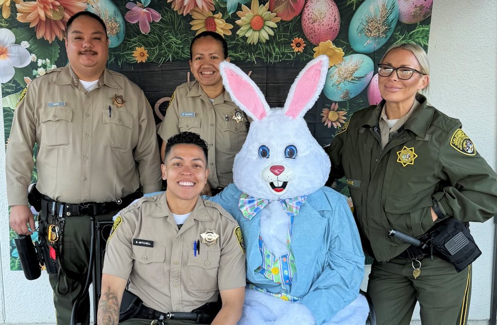 CDCR visiting staff pose for a group photo with the Easter bunny at Folsom State Prison.