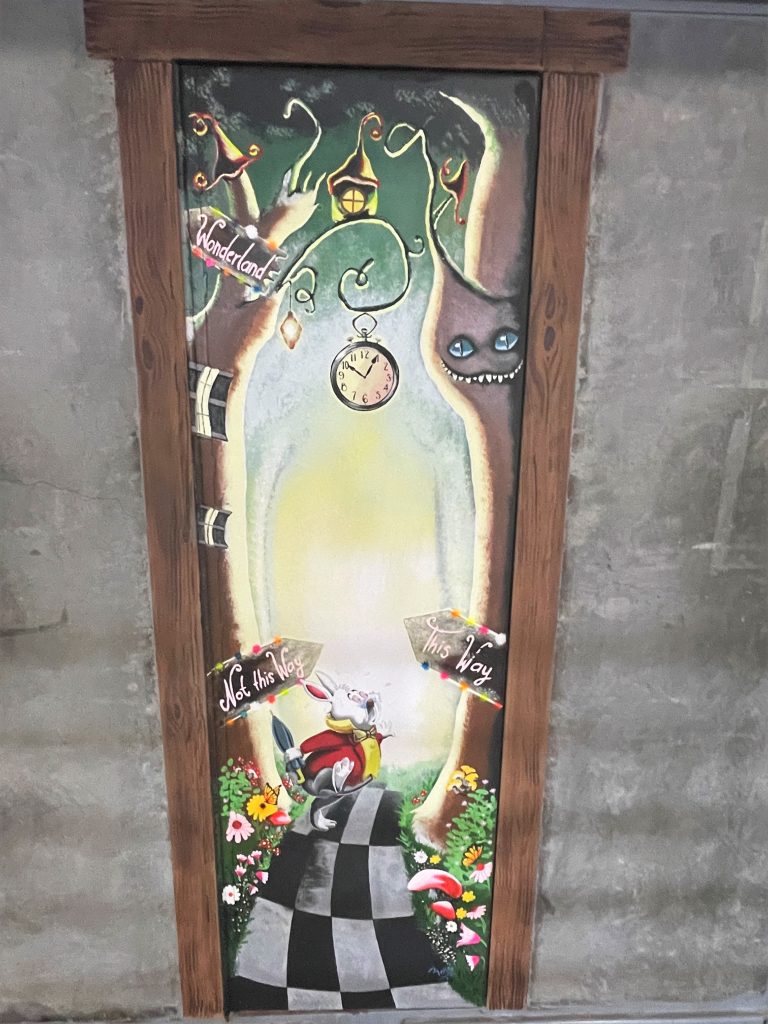Alice in Wonderland doorway painting at High Desert State Prison in Susanville, an art project headed up by a correctional officer.