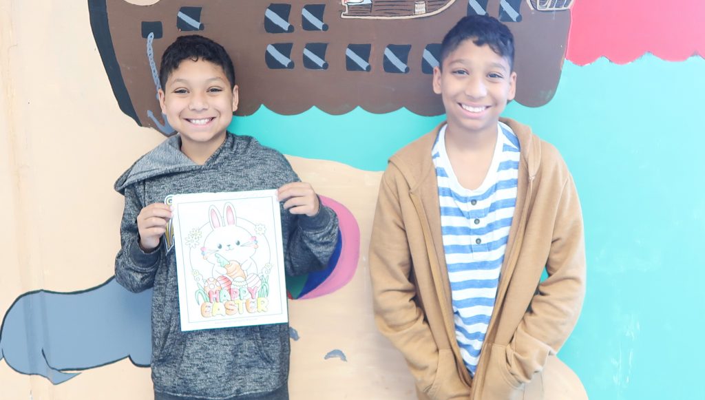 Two young boys with their coloring page for Easter.