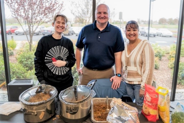 Headquarters health fair for CDCR and CCHCS with three people standing behind a table.