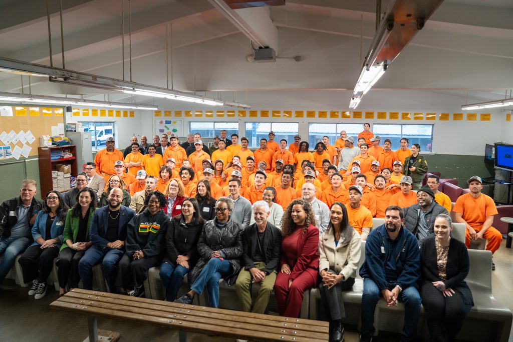 Legislators and incarcerated people at a conservation camp.
