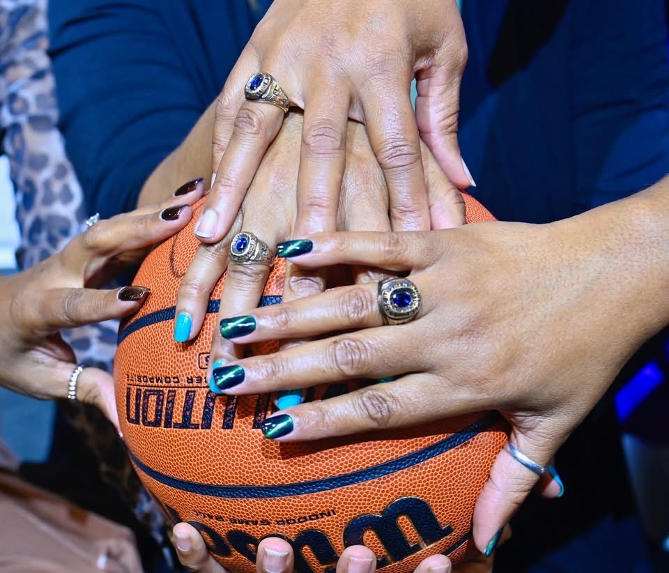 Robicheaux and her sisters hold a basketball.