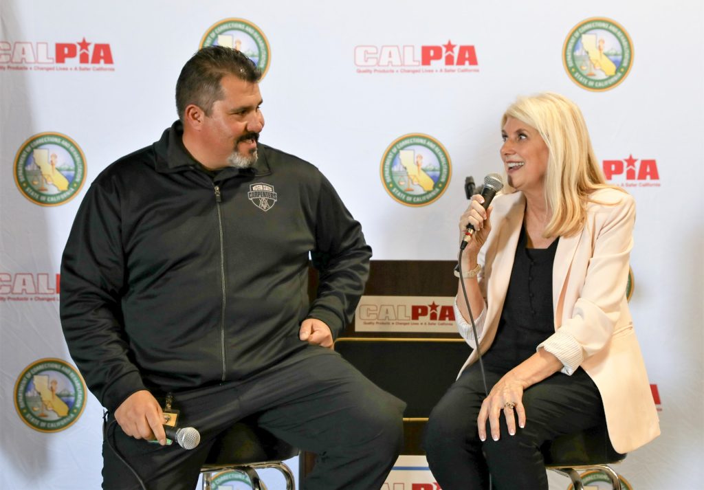 Ruben Minjarez speaks with CALPIA Assistant General Manager Michele Kane at CIM.