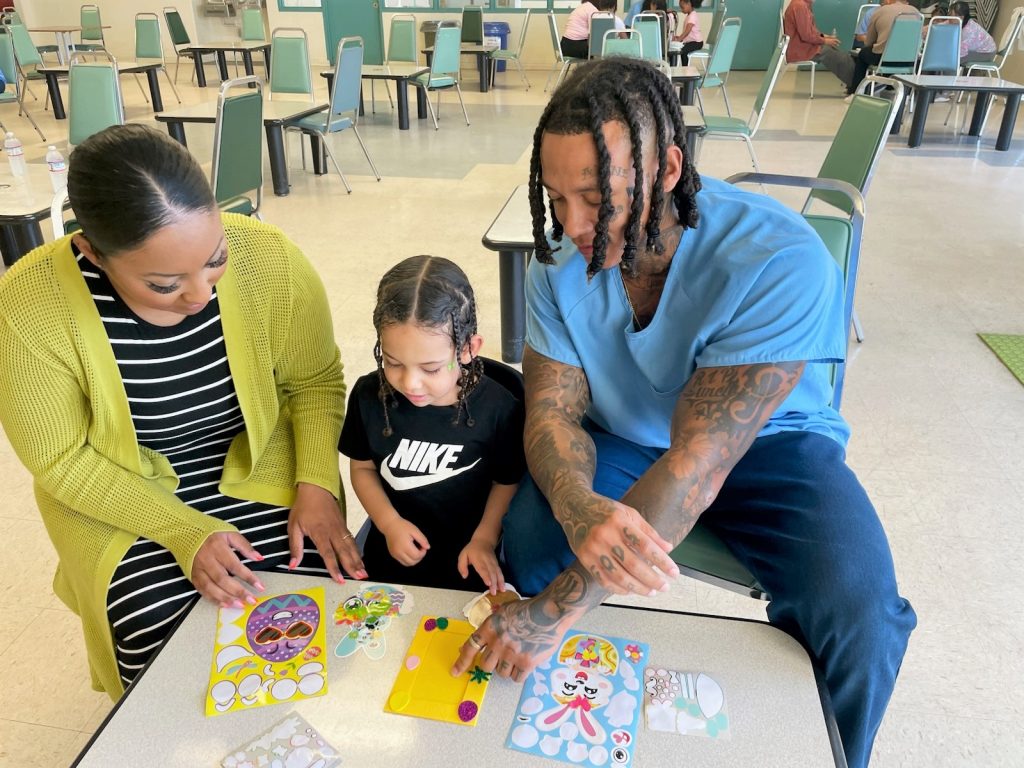 A family works on crafts activities at SATF for Easter.