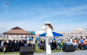 A music festival at SATF with a crowd in the background.