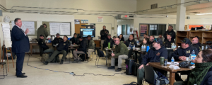 Warden addressing crisis response team at CCI
