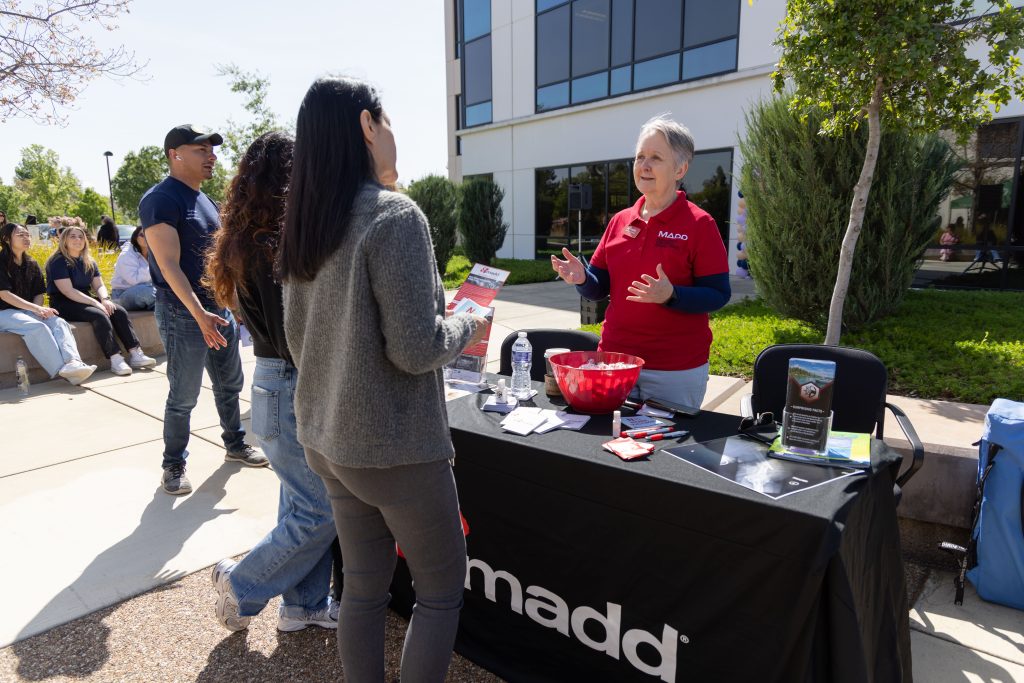 Bonnie Masters, with Mothers Against Drunk Driving, offers information to people at CDCR headquarters for the kick-off event.
