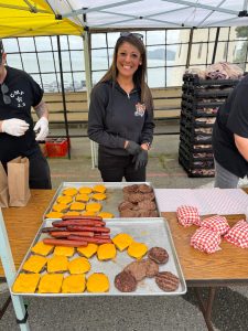 Associate Warden Nicole Avile preparing and serving food. 