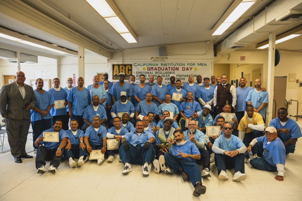 CIM graduates proudly holding certificates