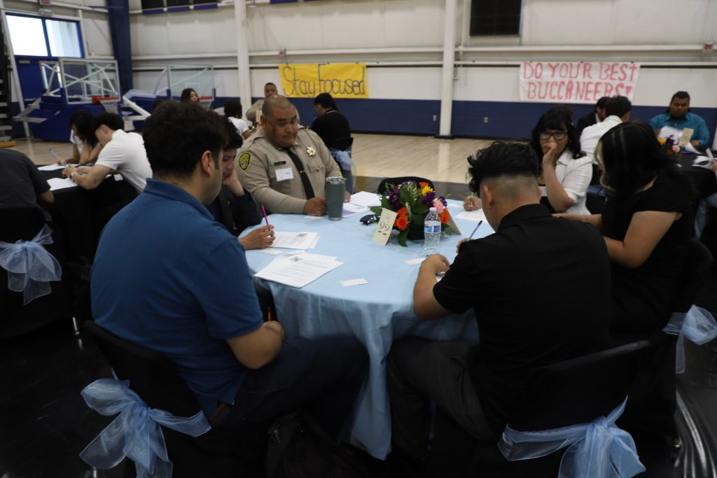 correctional officer speaking to students