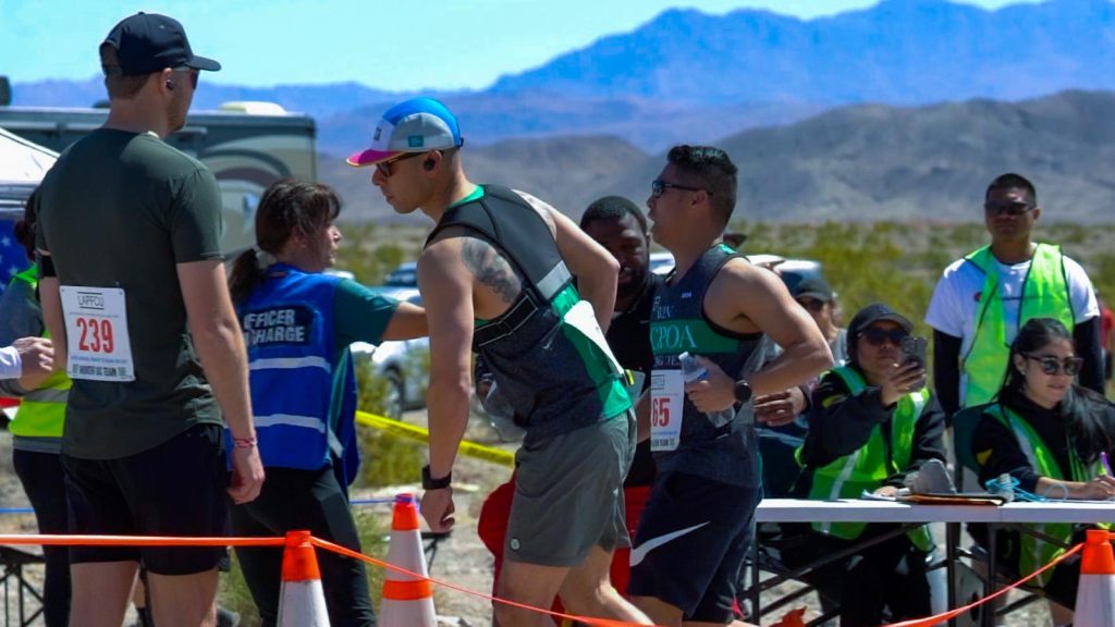 Baton hand-off during Baker to Vegas relay run.