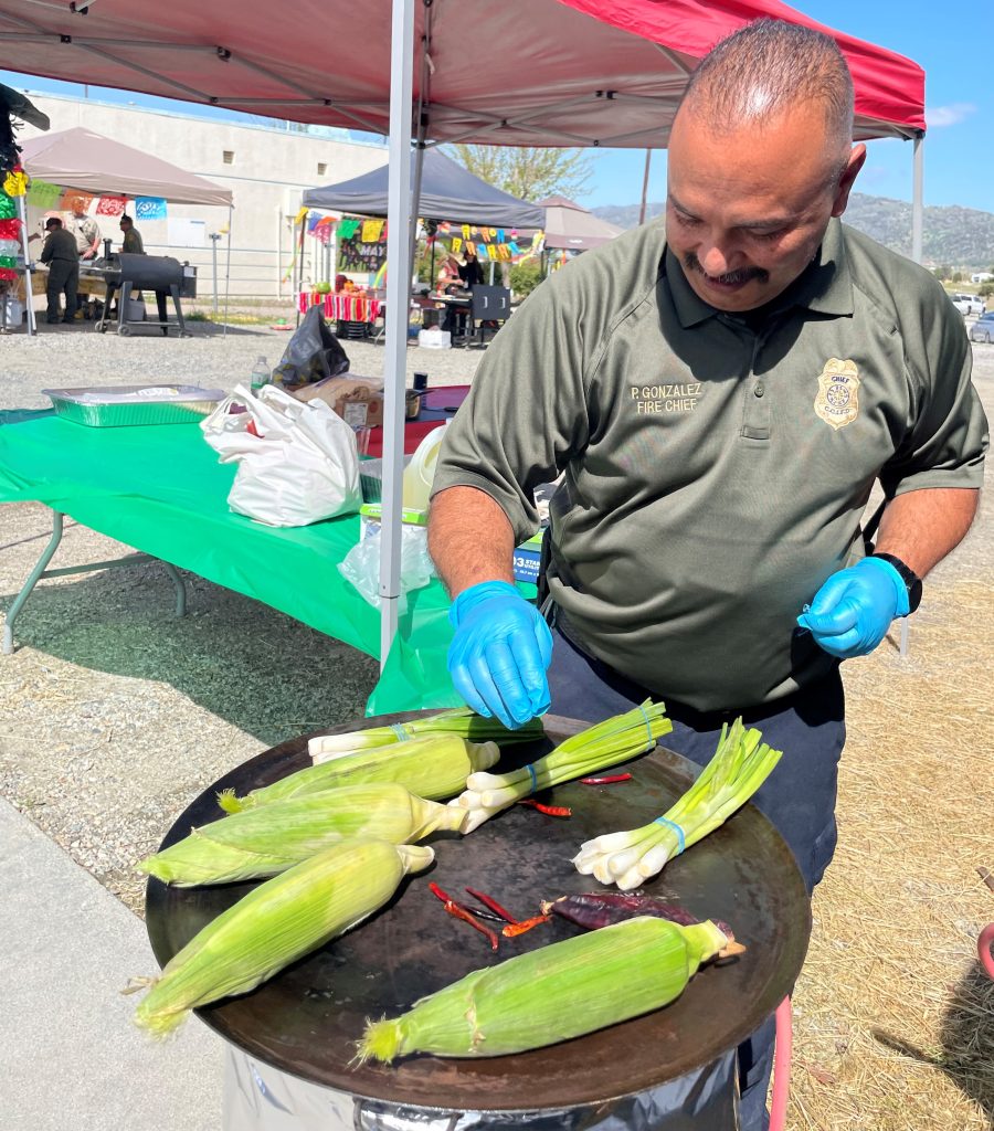 CCI Fire Chief Pete Gonzales grills corn for Cinco de Mayo.