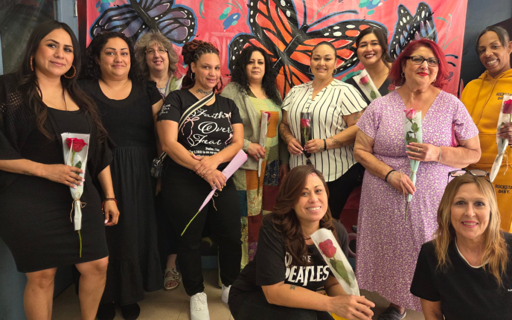 Women visiting their incarcerated loved ones on Mother's Day at CCI hold roses.