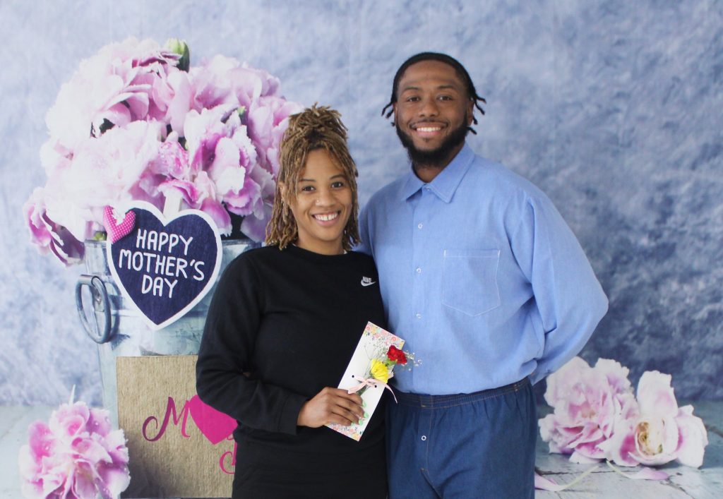 A man and woman pose for Mother's Day photos at Centinela State Prison Sunday, May 11, 2025.