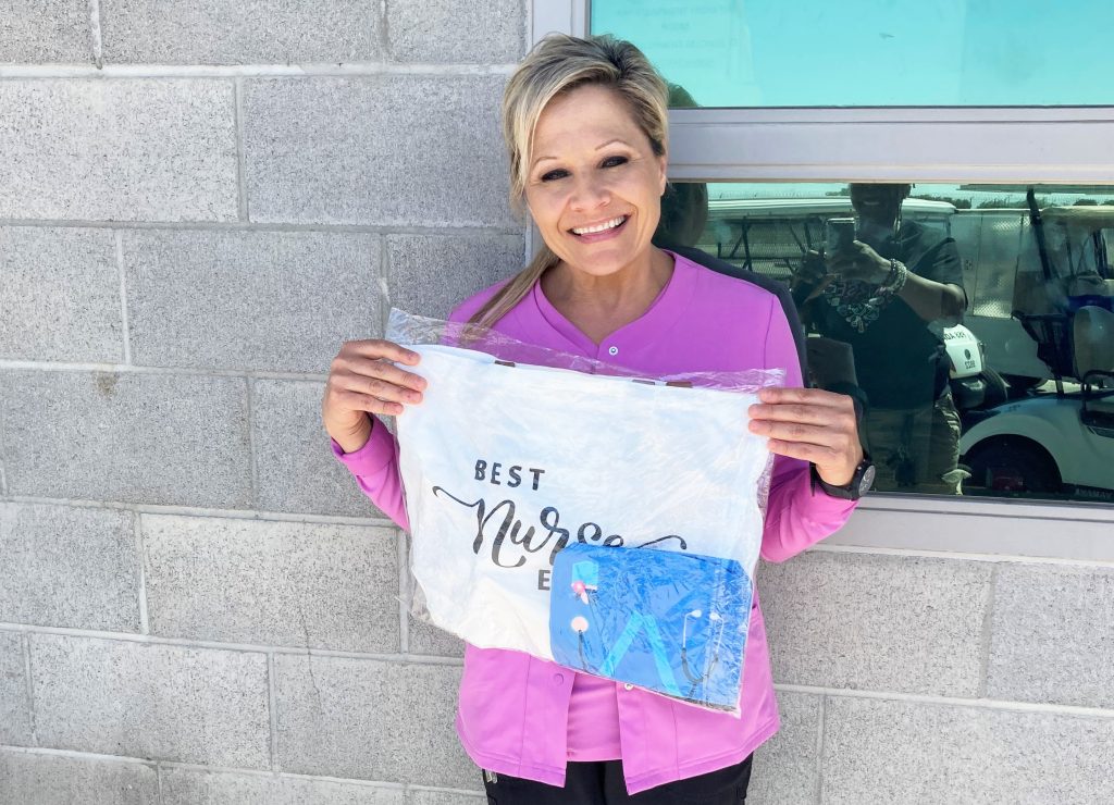 Nurse holds a "best nurse" gift bag at CHCF in Stockton for staff appreciation week.