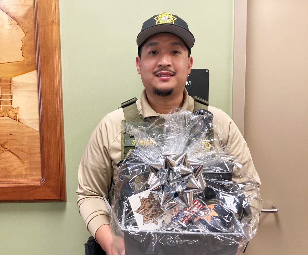 Officer holds a gift basket at CHCF in Stockton, California. 