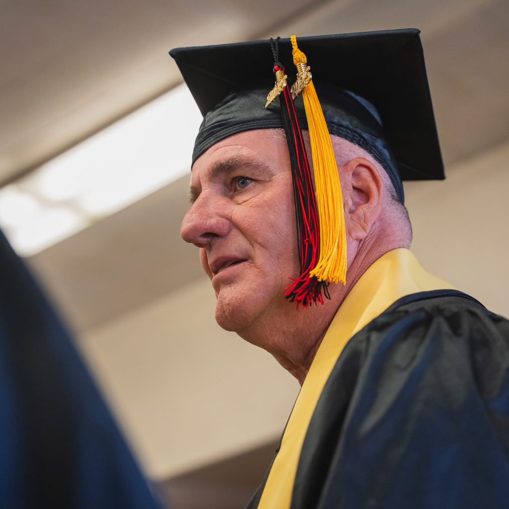 A graduate wearing a cap and gown.