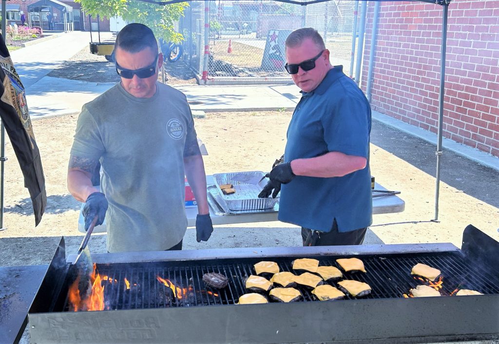 Management grills hamburgers and hotdogs as a staff appreciation gesture at California Institution for Women in Chino. 