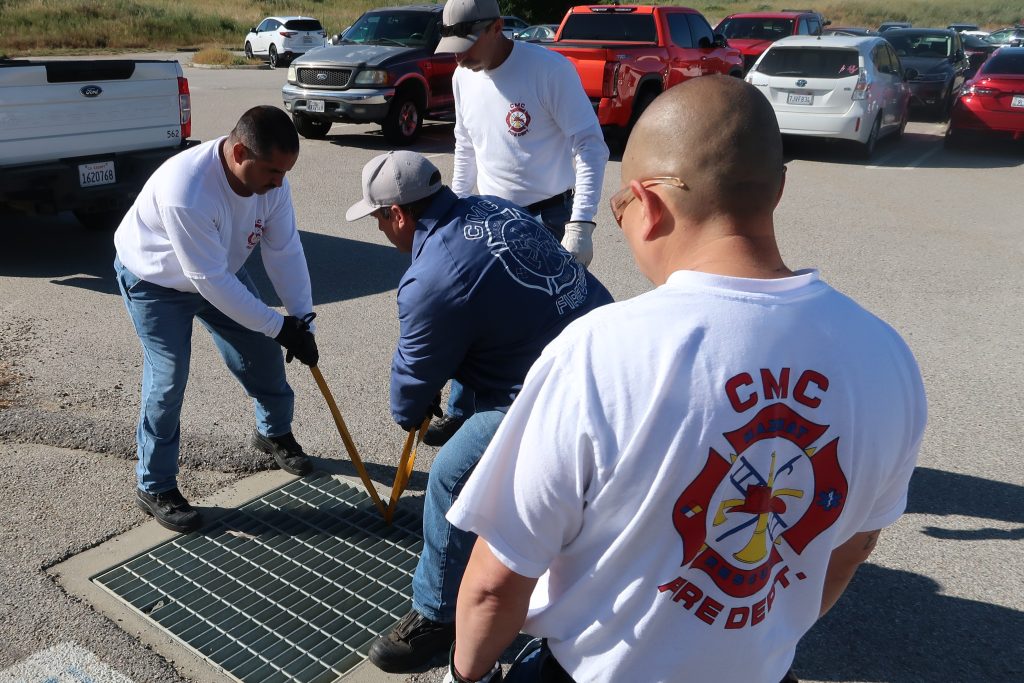 Opening a storm drain grate to save ducklings at CMC.