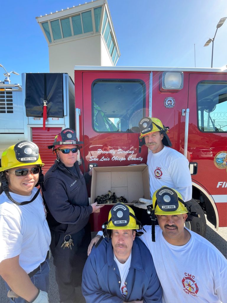 Firefighters with a box of ducklings they saved at CMC.