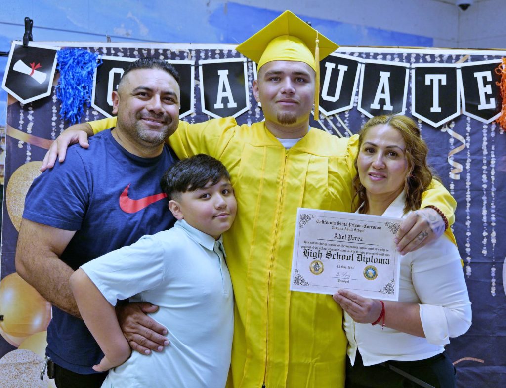 One of the 80 students to graduate with his family at California State Prison, Corcoran, Visions Adult School.