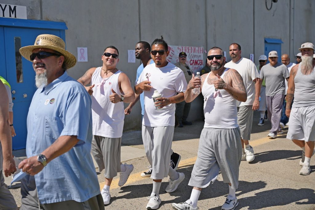 Incarcerated people walk along a track during CSP-Corcoran cancer walks to benefit Valley Children's Hospital.