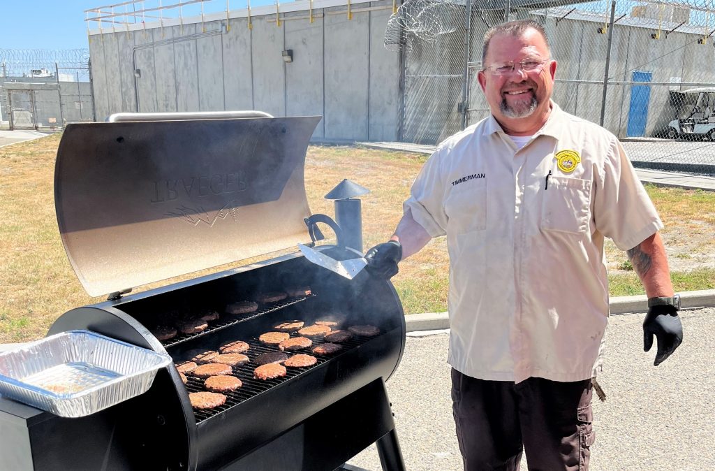 A staff member at CSP-Corcoran works the barbecue.