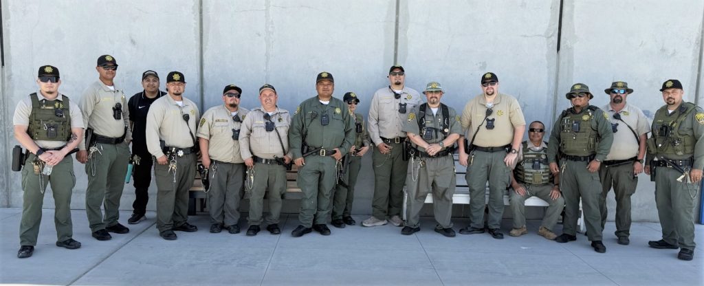 Group photo of custody staff lined up against a wall at CSP-Corcoran.