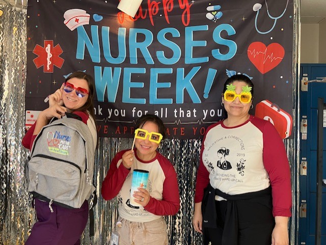 ISUDT staff take a photo in front of a backdrop at CSP-Corcoran.