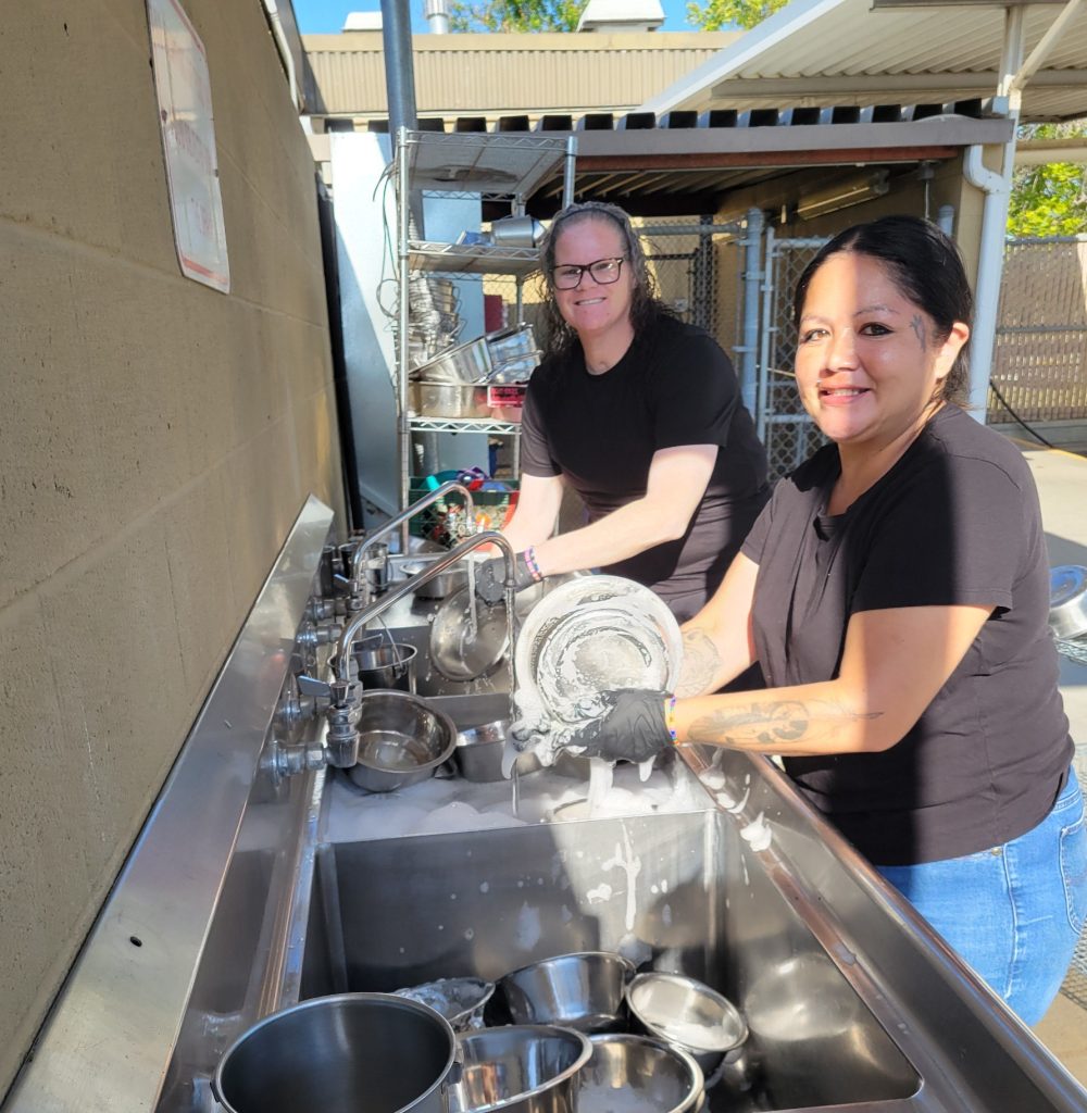 Participants washing feeding bowls