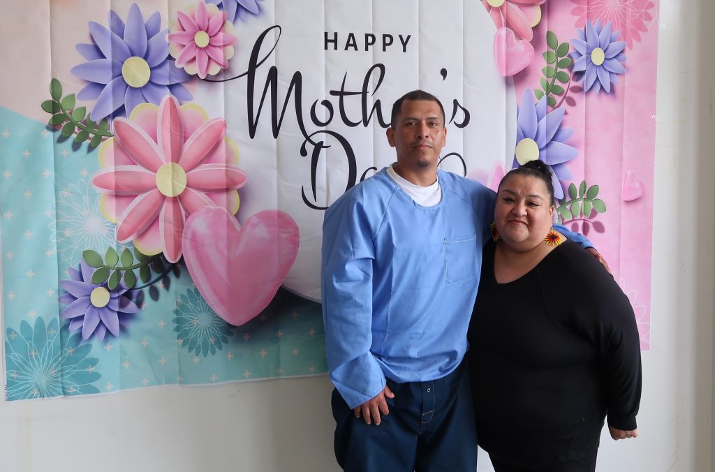 Mother's Day visiting with two people posing for a photo at High Desert State Prison, Susanville, California.