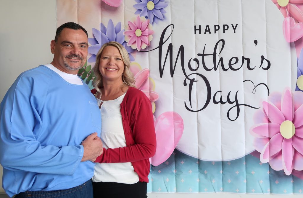 Two people hug during Mother's Day visiting at High Desert State Prison, Susanville, California.