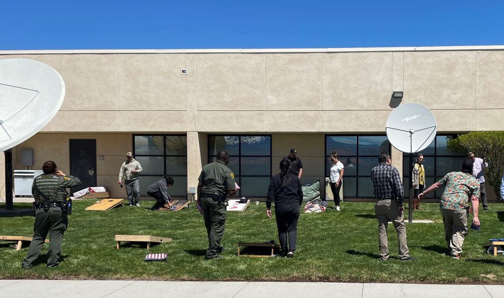 Staff play corn hole at High Desert State Prison in Susanville during a staff appreciation event in early May 2025.