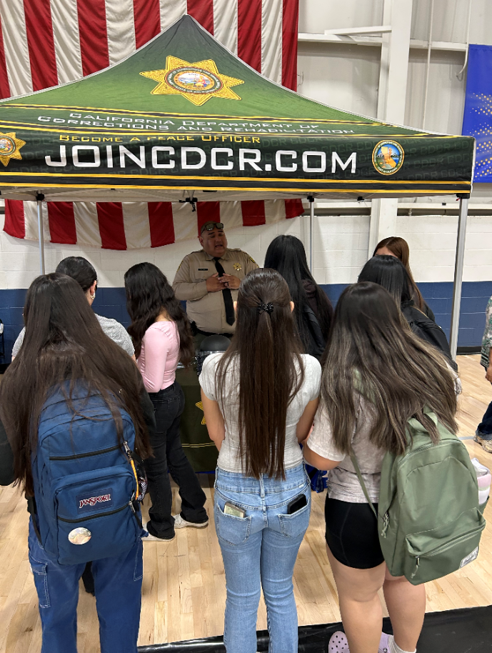 Students gathered around CDCR booth at career day