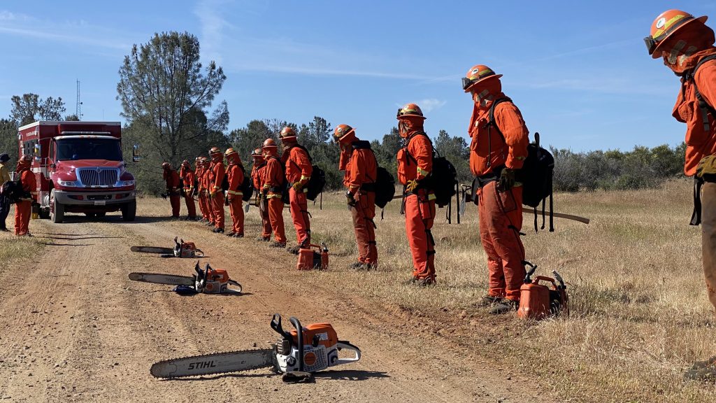 IP firefighters standing next to gear