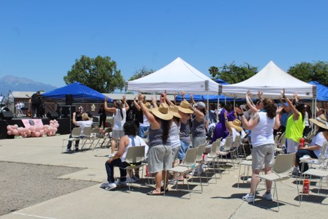 Audience members standing in praise, dancing