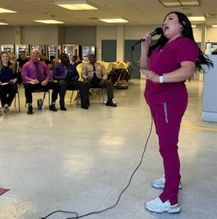 A nurse sings into a microphone at Kern Valley State Prison.