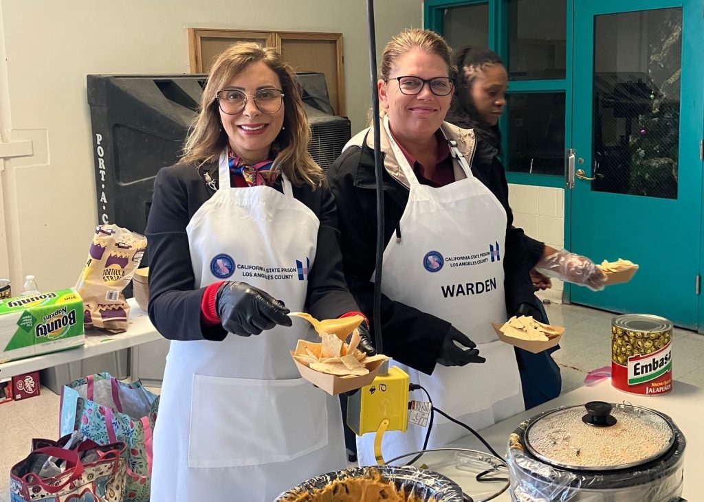 Warden and CEO serve nachos during the staff appreciation event at LAC.
